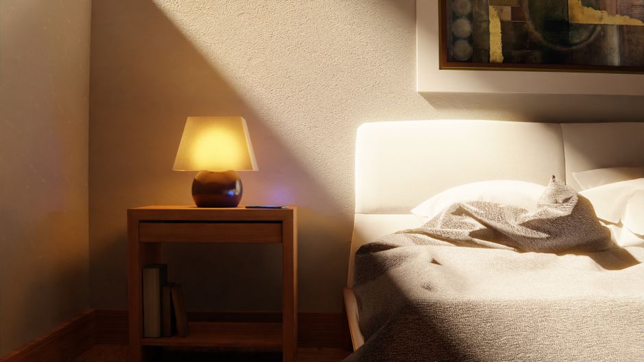 A warm bedside lamp glowing in a dark bedroom
