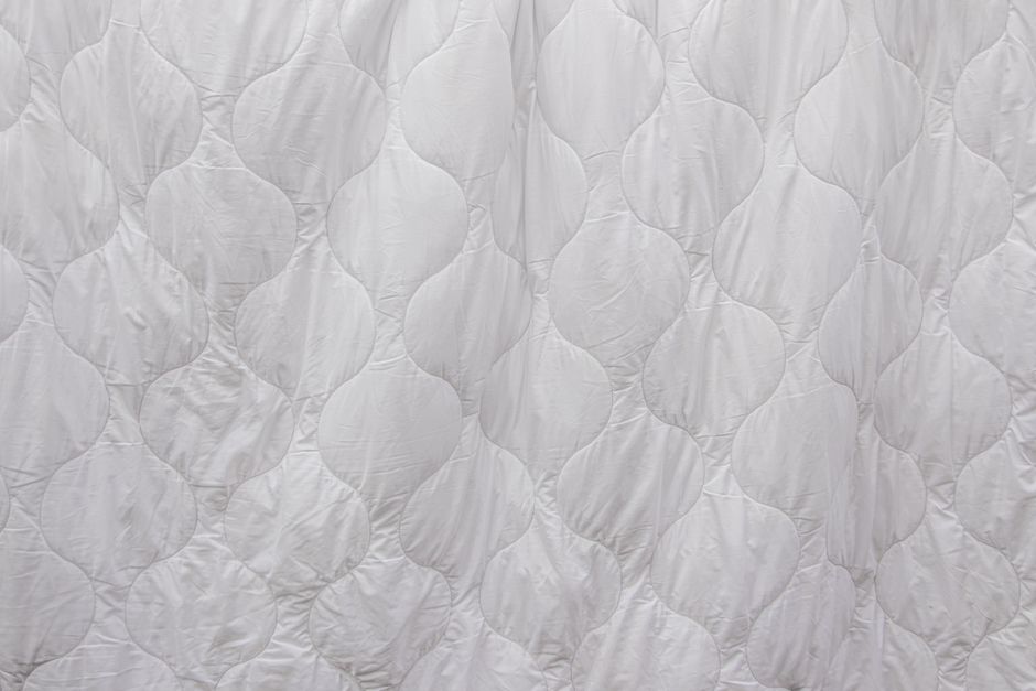Close-up of quilted white bedding