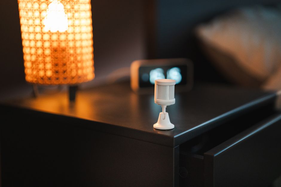 Compact white noise machine on a minimal bedside table