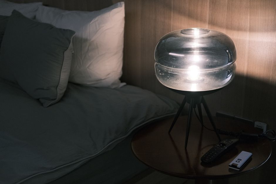 Fan-based white noise machine in a calm dark bedroom