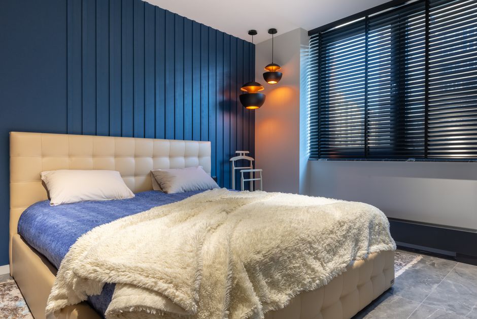 Portable blackout blind darkening a bedroom window