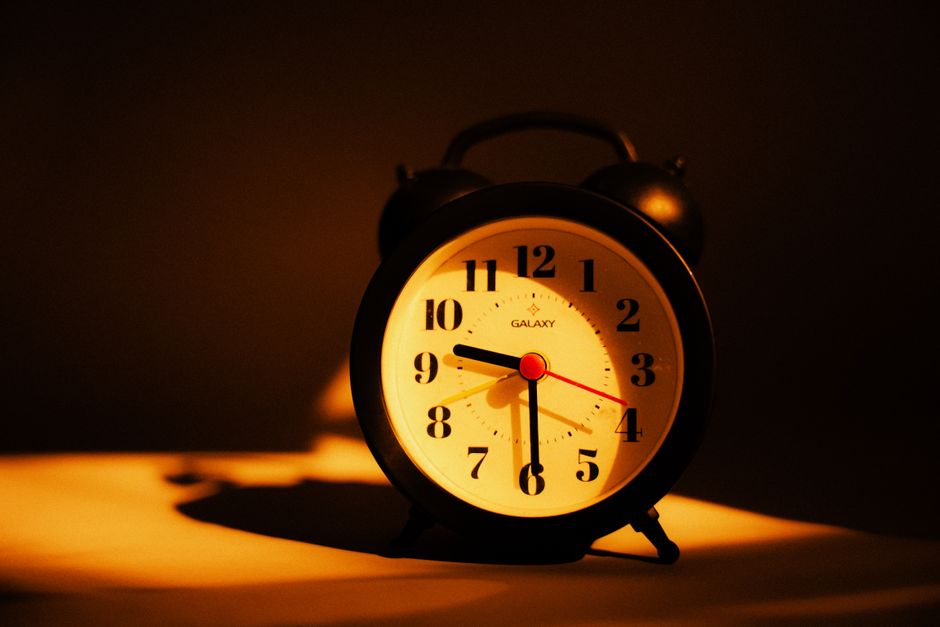 Wake-up light simulating sunrise on a bedside table at dawn