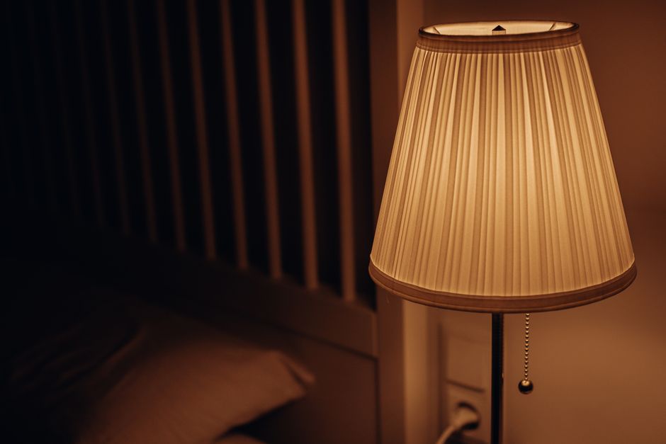 Warm bedside wake-up light glowing in a dark bedroom